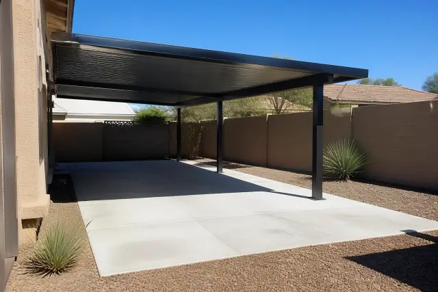 A completed freestanding steel carport on a concrete driveway in Phoenix, AZ with desert landscaping.