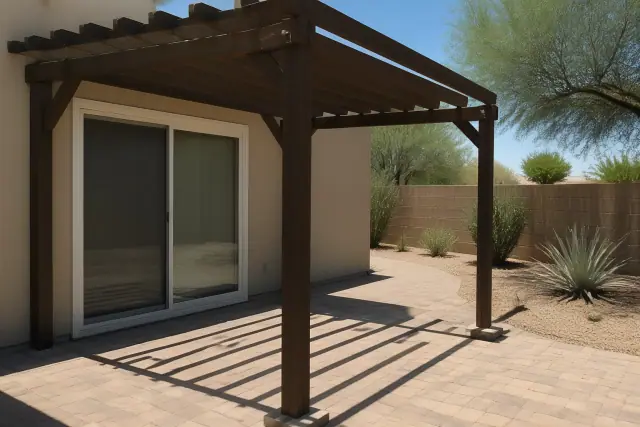 Structural skeleton of a freestanding pergola on a stone patio in Phoenix, AZ.