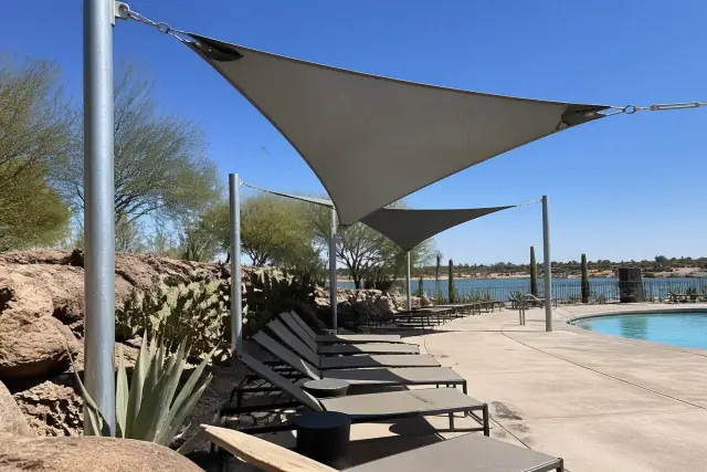 HDPE fabric shade structures over lounge chairs at a commercial pool deck in Phoenix, AZ.