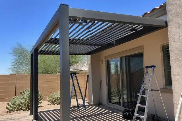 Aluminum louvered roof installation over a paved residential patio in Peoria, AZ.