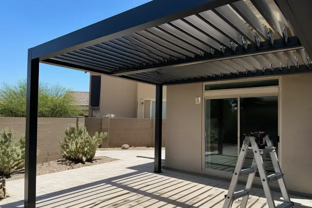 Louvered roof installation over a residential patio with prickly pear cactus in Gilbert, AZ.