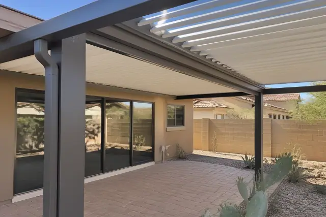 Adjustable aluminum louvered roof installed over a residential backyard patio in Scottsdale, AZ.