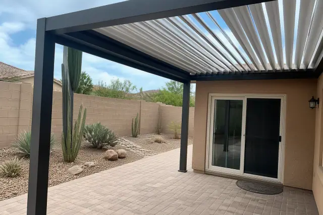Louvered roof installed over a backyard patio with desert landscaping at a home in Phoenix, AZ.