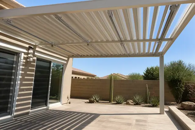 Louvered roof installation over a stone patio in a xeriscaped backyard in Chandler, AZ.