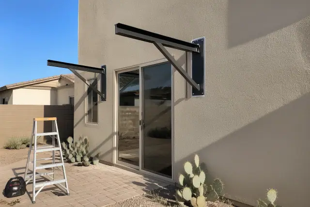 Metal awning installation above a sliding glass door on a residential patio in Gilbert, AZ.