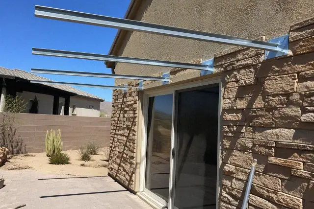 Metal awning installation for a backyard patio shade structure in Goodyear, AZ.