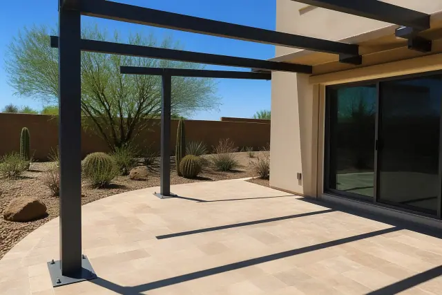 Steel mounting brackets and support beams for a patio cover installation on stone pavers in Scottsdale, AZ.