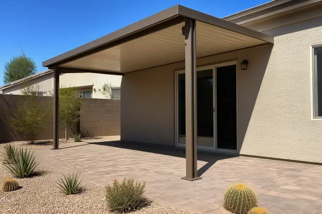 Completed metal patio cover installed over a paved backyard patio in Phoenix, AZ.