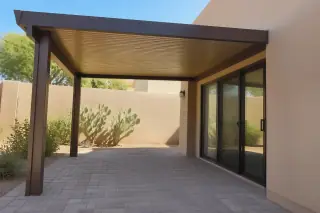 Finished wooden patio cover with sturdy support posts and prickly pear cactus in a Phoenix, AZ backyard.