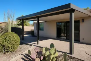 Modern patio cover providing shade over a stone floor in a desert backyard in Phoenix, AZ.