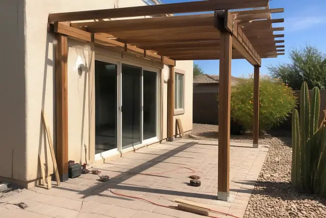 Pergola under construction on a residential stone patio in Phoenix, AZ.