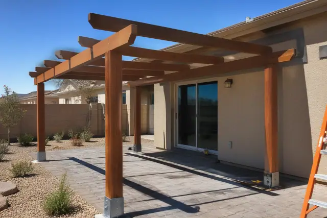 Stained cedar pergola installed over a stone patio in a residential backyard in Queen Creek, AZ.