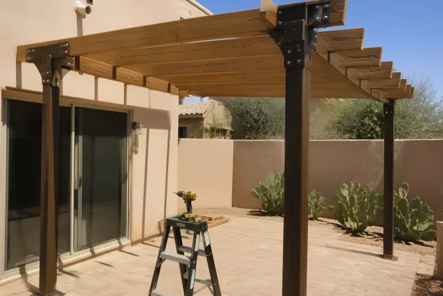 Pergola installation in progress with wooden rafters and steel joists on a residential patio in Scottsdale, AZ.
