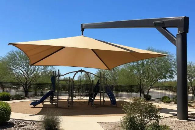 Cantilever shade canopy over a playground with desert landscaping in Phoenix, AZ.