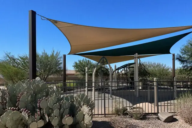 Completed shade sail installation over playground equipment in a desert park in Phoenix, AZ.