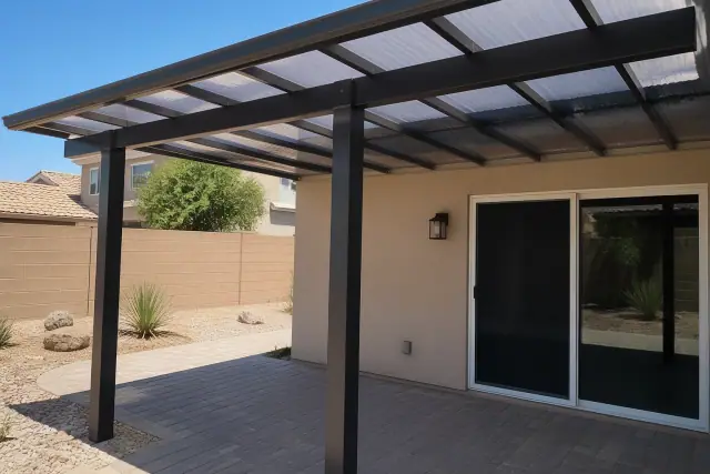 Polycarbonate patio cover installed over a paved residential backyard in Phoenix, AZ.