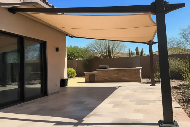 Steel cantilever shade structure over a residential stone patio in Phoenix, AZ.