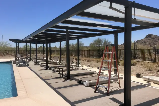 Shade structures installed over lounge chairs on a commercial pool deck during a hot summer day in Phoenix, AZ.