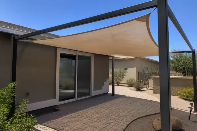 Powder-coated frame with a weathered shade sail over a paved patio in Phoenix, AZ.