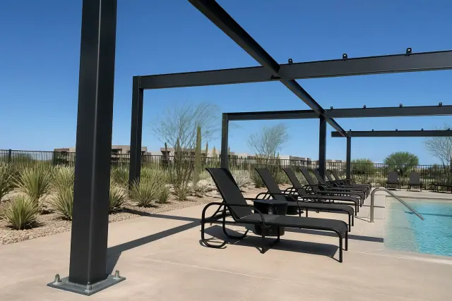 Powder-coated steel frames for shade structures on a pool deck in Phoenix, AZ.