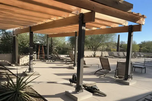 Steel pergola construction over a pool deck lounge area in Phoenix, AZ.