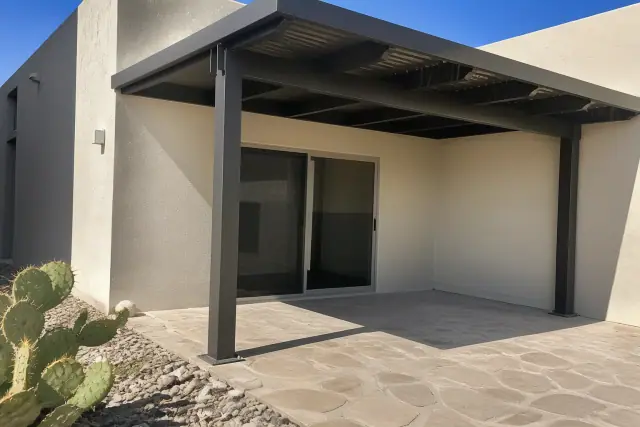 Steel support posts for a shade structure bolted into a stone patio at a home in Peoria, AZ.