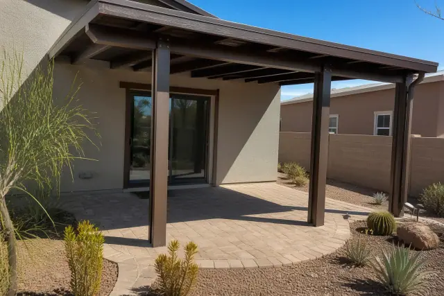 Completed ramada patio cover over a stone paved area at a home in Phoenix, AZ.