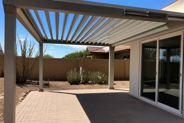 Retractable louvered roof installed over a residential patio in Phoenix, AZ, with desert landscaping.