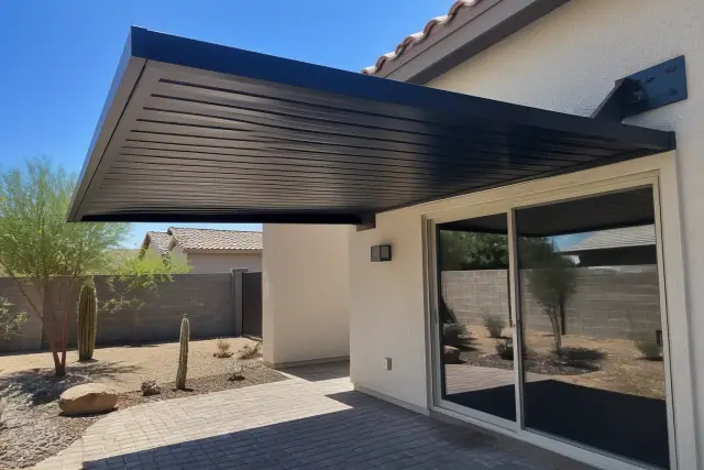 Rigid aluminum shade covers installed over a paved patio in Phoenix, AZ.