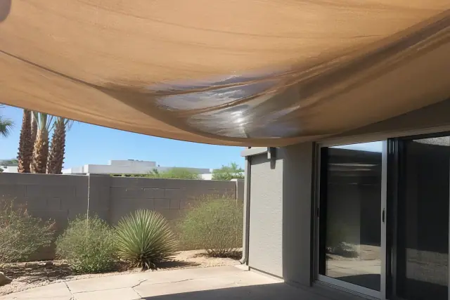 Sagging fabric causing water pooling above a stone patio in Phoenix, AZ.
