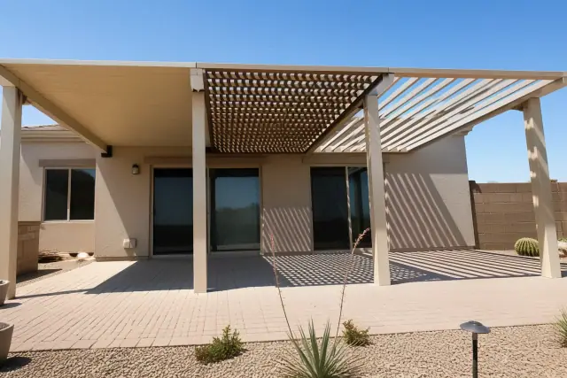 Patio area with solid, lattice, and louvered roof covers providing shade in a Phoenix, AZ backyard.
