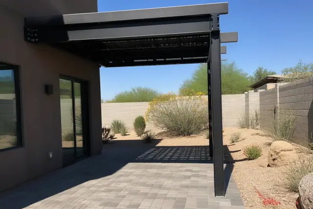 Steel and cantilever structure installation over a patio in Phoenix, AZ, set against xeric desert landscaping.