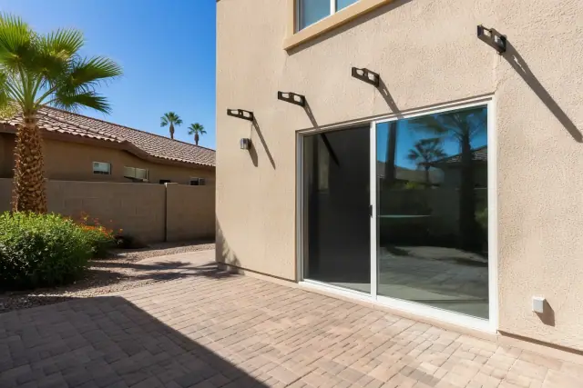 Metal awning brackets installed above a sliding glass door on a residential patio in Phoenix, AZ.