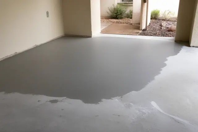 Smooth gray leveling compound applied to a concrete floor slab in a Phoenix, AZ home under construction.