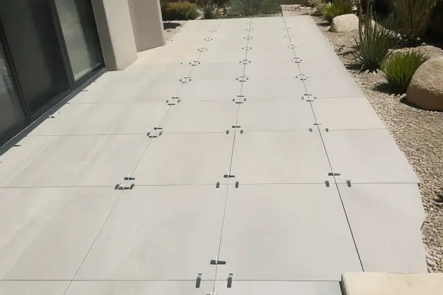 Exterior porcelain tile installation on a residential patio in Phoenix, AZ, showing tiles with mortar haze.
