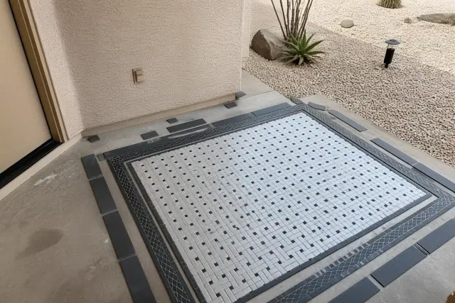Glass mosaic and accent tiles laid out on a floor for a bathroom renovation project in Phoenix, AZ.