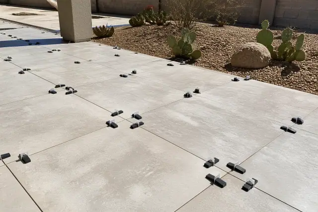 Large format tiles with leveling clips and wedges during installation at a job site in Chandler, AZ.
