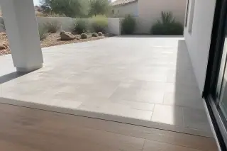 Finished natural stone patio tile installation next to a residential home in Phoenix, AZ.
