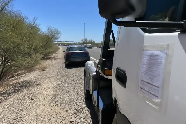 A laminated tow truck permit attached to a door during a highway equipment inspection in Phoenix, AZ.
