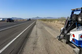 Cleared gravel highway shoulder with tire tracks and desert scenery in Phoenix, AZ.