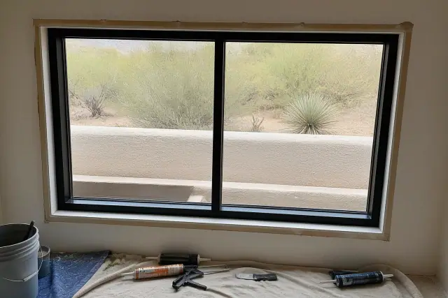Aluminum window frame installation in progress on a stucco wall at a jobsite in Scottsdale, AZ.