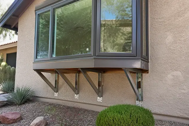 Support brackets being reinforced under a bay window on a stucco house in Phoenix, AZ.