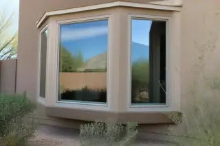 Finished bay window installed on a stucco home with desert landscaping in Phoenix, AZ.
