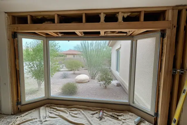 Bay window structural framing with header installation at a residential construction site in Phoenix, AZ.