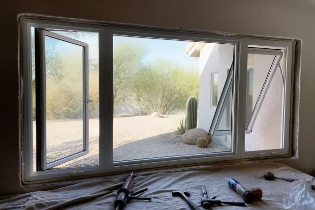 Casement and awning window installation in a stucco wall at a jobsite in Phoenix, AZ.