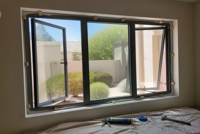 Newly installed casement and awning windows with fresh sealant in a Phoenix, AZ home.