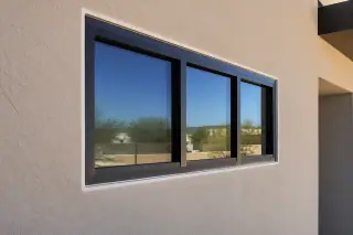 Clean caulk line on a new window frame against a stucco wall at a home in Phoenix, AZ.
