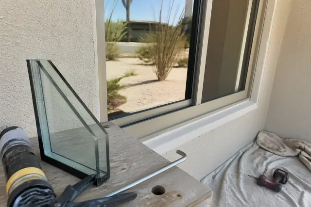 A window installation project with glass samples and sealant tools in a home in Phoenix, AZ.