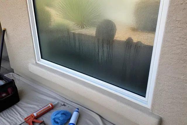 Condensation and moisture trapped between double pane window glass on a jobsite in Phoenix, AZ.