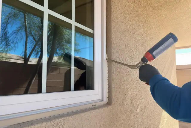 A newly installed energy-efficient window on a stucco wall in Tempe, AZ.